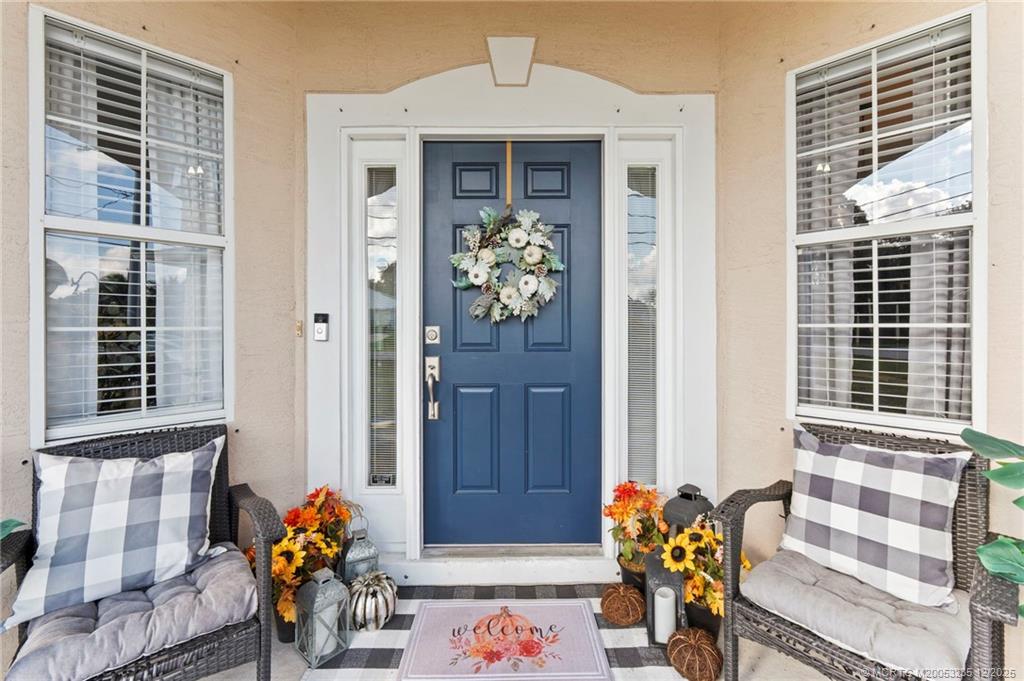 801 Southwest Tulip Boulevard Port St. Lucie, FL 34953 - Photo 6 of 41 a front view of a house with outdoor seating