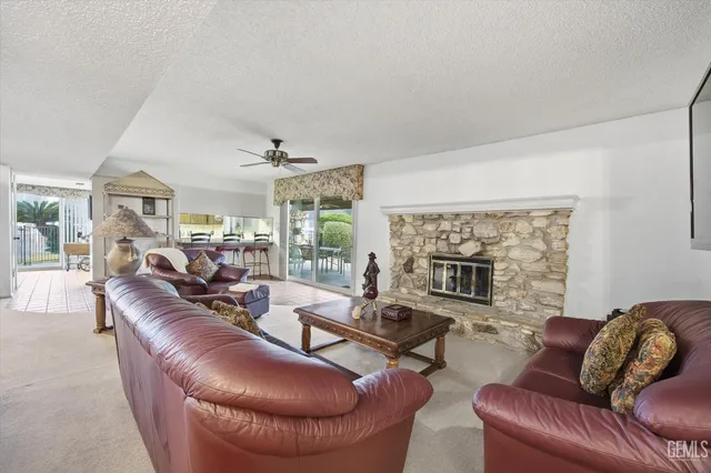 a living room with furniture a chandelier and a window