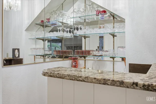 a bedroom with a large bed and a flat tv screen on the dresser