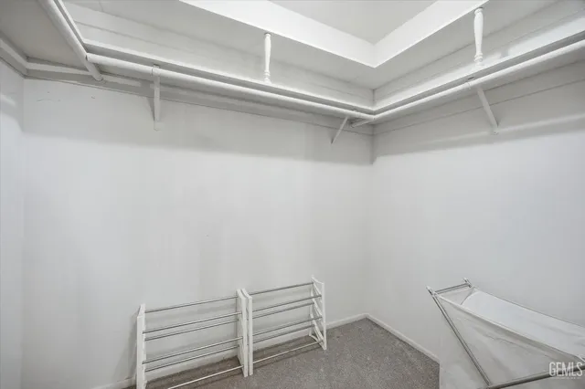 a view of a swimming pool with a chairs and plants