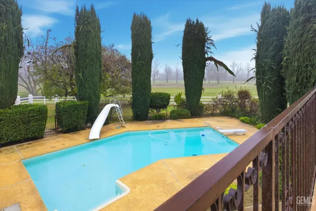 a view of a swimming pool with an outdoor space and seating area