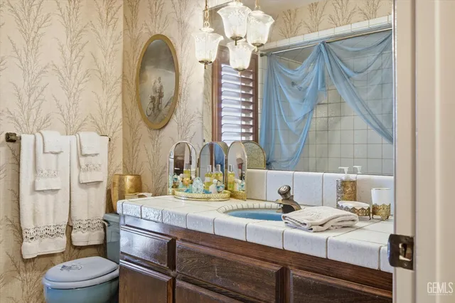 an aerial view of a house with garden space and a view of a swimming pool