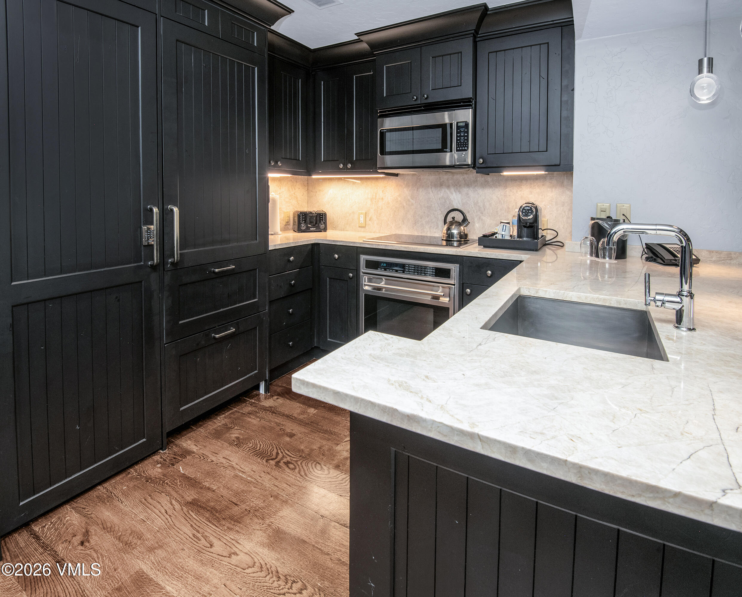 130 Daybreak Ridge Road, Unit HS716 Avon, CO 81620 - Photo 8 of 25 a kitchen with granite countertop a sink dishwasher stove and cabinets