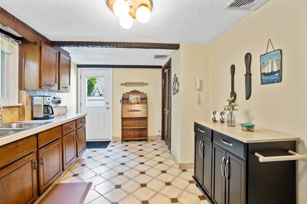 19 Belcher Street Winthrop, MA 02152 - Photo 13 of 33 a kitchen with a sink stove and cabinets