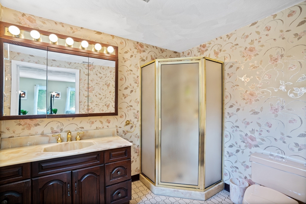 19 Belcher Street Winthrop, MA 02152 - Photo 17 of 33 a bathroom with a sink a toilet a mirror and shower