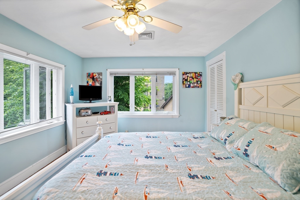 19 Belcher Street Winthrop, MA 02152 - Photo 21 of 33 a bedroom with a bed window and a flat screen tv