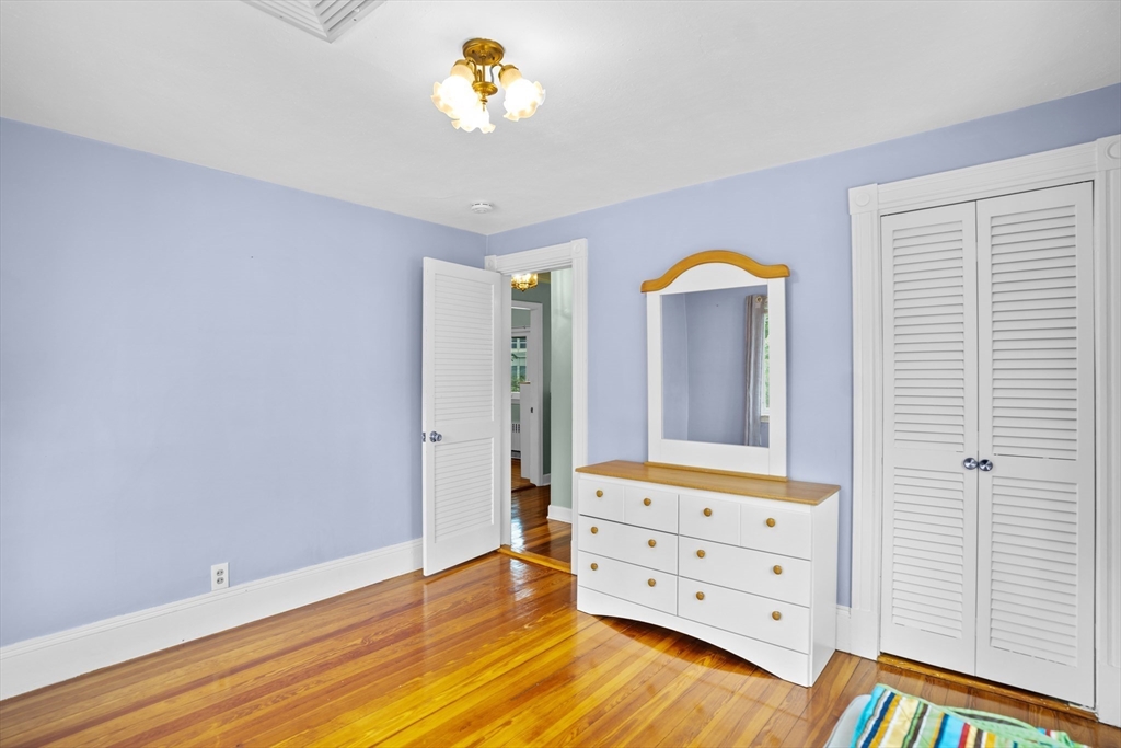 19 Belcher Street Winthrop, MA 02152 - Photo 25 of 33 wooden floor with a cabinet and a mirror