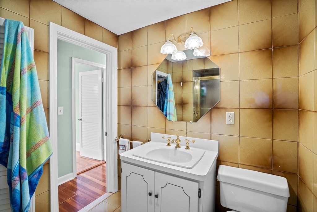 19 Belcher Street Winthrop, MA 02152 - Photo 27 of 33 a bathroom with a sink a vanity and a mirror