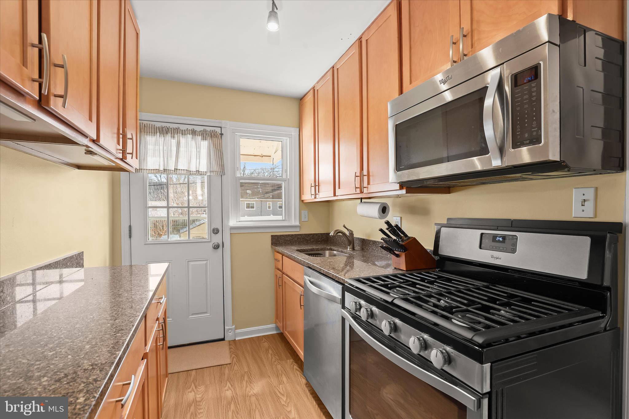 1207 Brewster Street Halethorpe, MD 21227 - Photo 11 of 34 a kitchen with stainless steel appliances granite countertop a stove a microwave and a sink