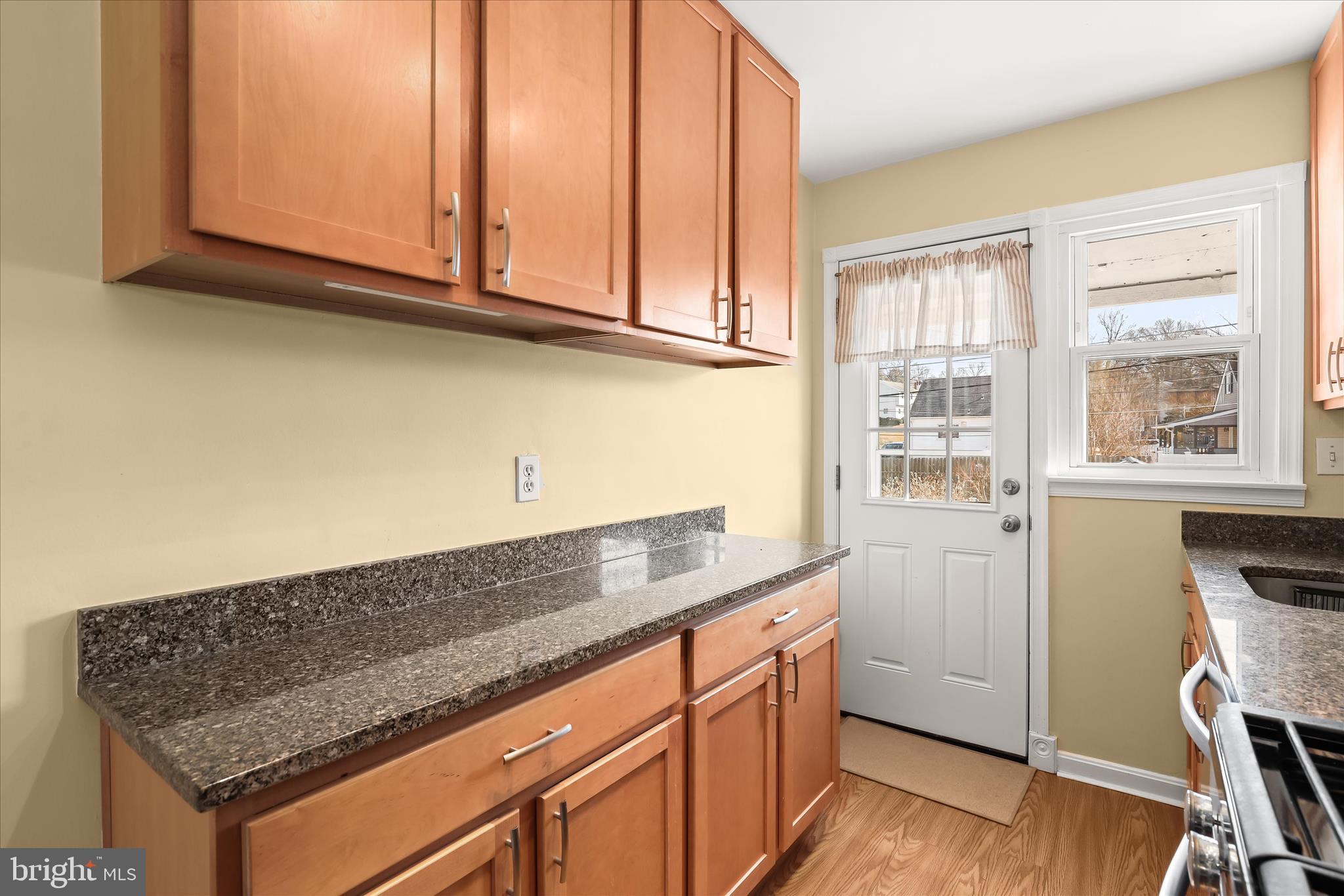 1207 Brewster Street Halethorpe, MD 21227 - Photo 12 of 34 a kitchen with granite countertop cabinets stainless steel appliances a sink and a window
