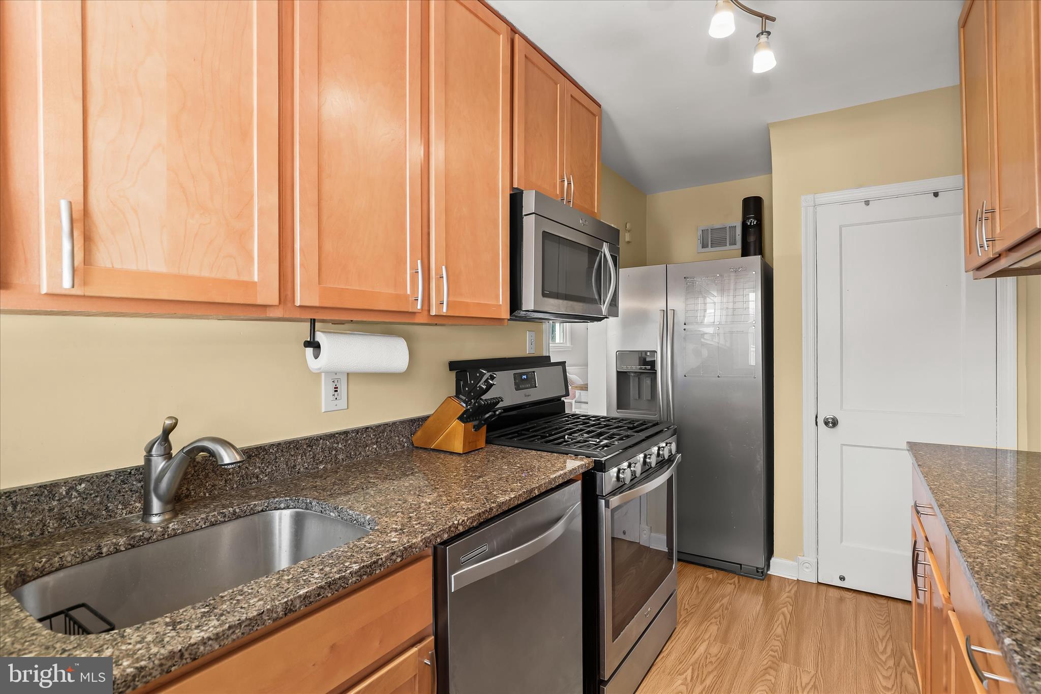 1207 Brewster Street Halethorpe, MD 21227 - Photo 15 of 34 a kitchen with stainless steel appliances granite countertop a sink stove and refrigerator