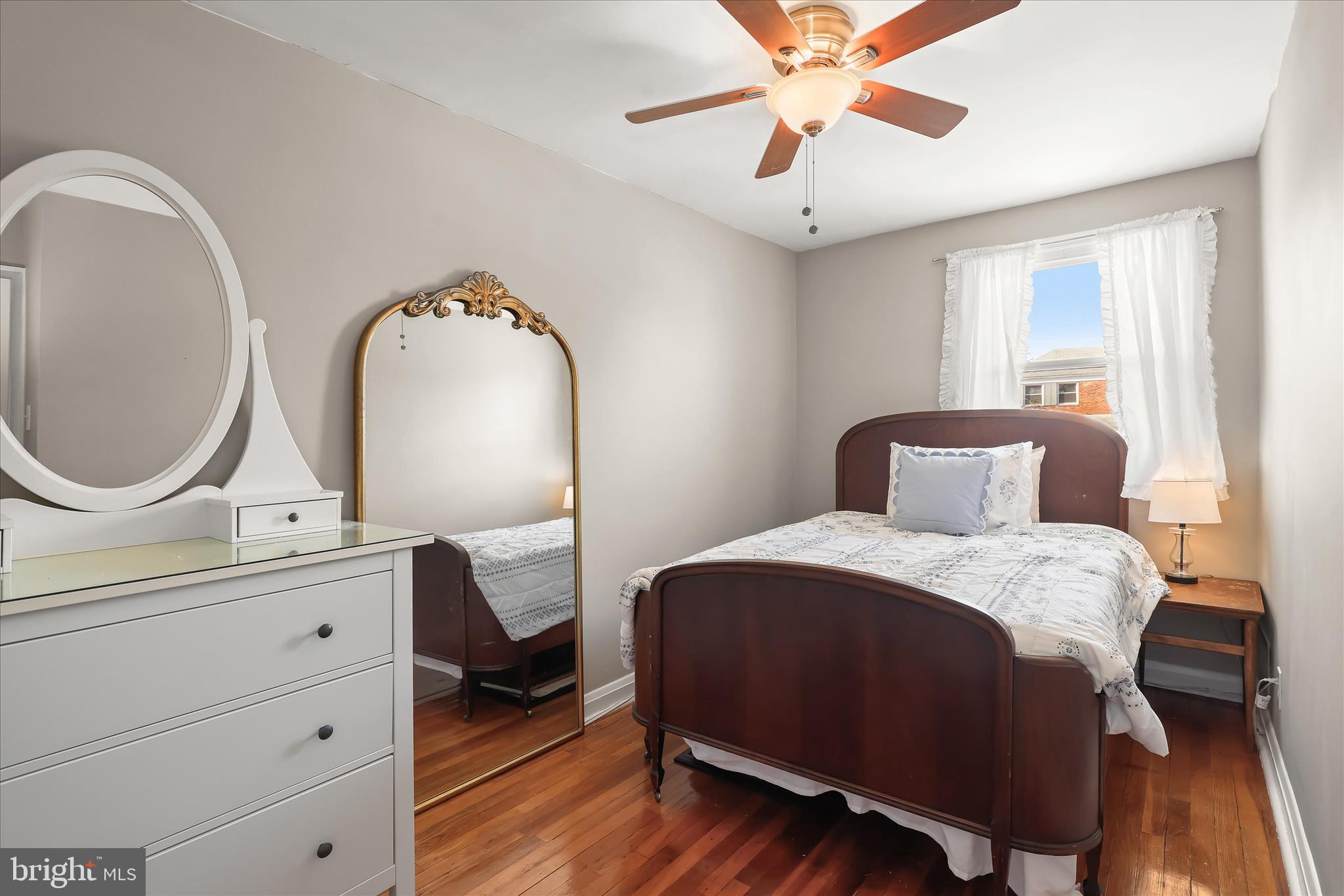 1207 Brewster Street Halethorpe, MD 21227 - Photo 19 of 34 a bedroom with a bed a mirror and a chandelier