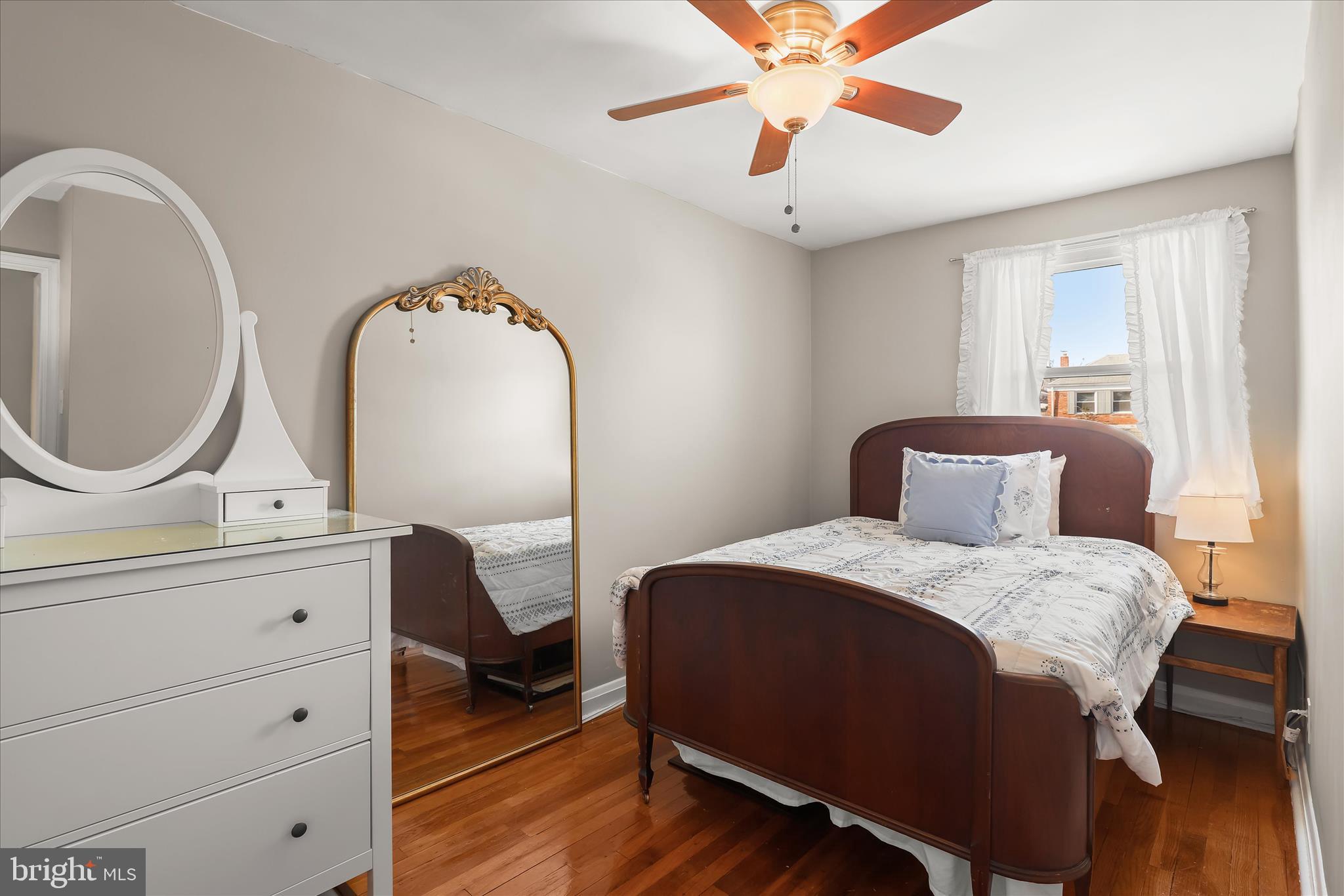 1207 Brewster Street Halethorpe, MD 21227 - Photo 20 of 34 a bedroom with a bed and a chandelier