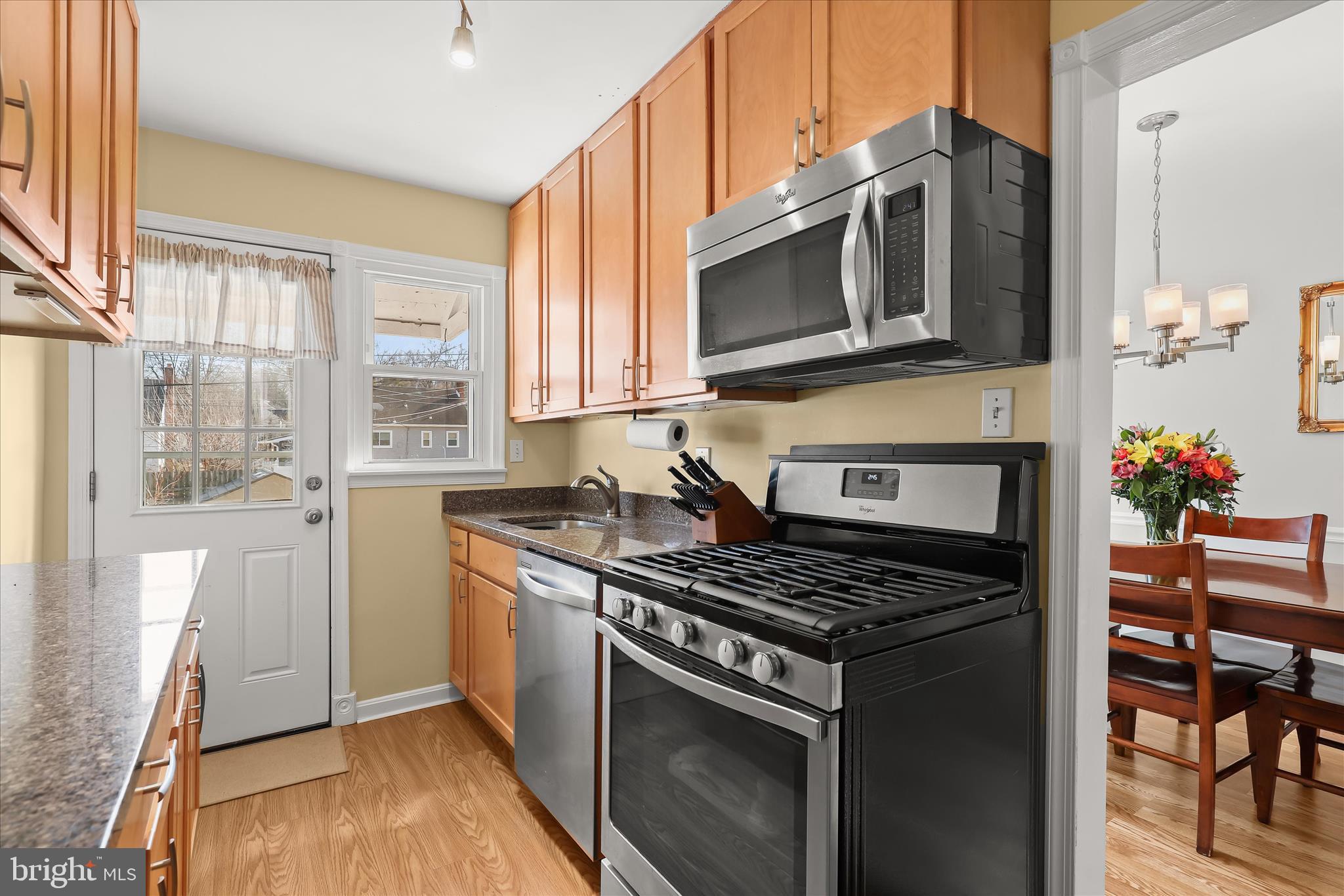 1207 Brewster Street Halethorpe, MD 21227 - Photo 10 of 34 a kitchen with stainless steel appliances granite countertop a stove and a microwave