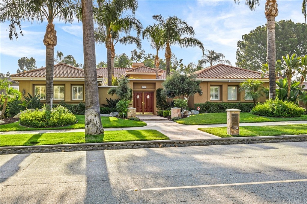 6718 Etiwanda Avenue Rancho Cucamonga, CA 91739 - Photo 1 of 1 a front view of a house with a yard and palm trees