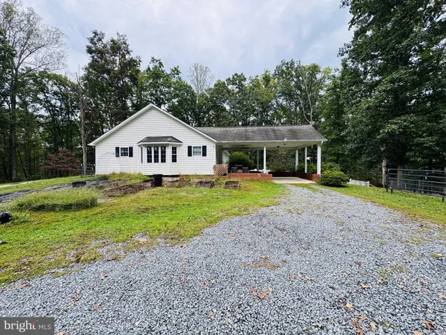 a view of a house with a yard and potted plants