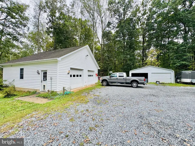 a view of a house with a yard and potted plants