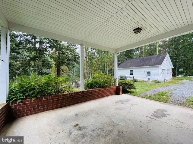 a house with green field in front of it