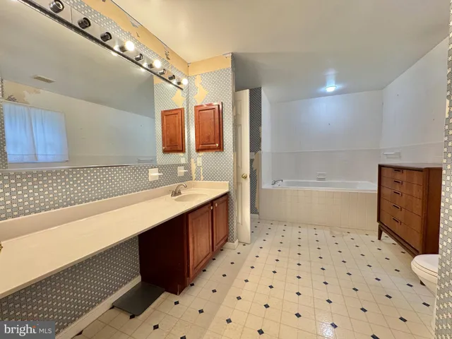 a kitchen with stainless steel appliances granite countertop wooden floors and view living room