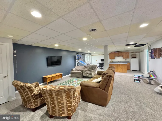 a kitchen with a sink a cabinets and wooden floor