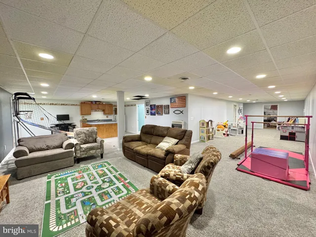 a dining room with a table chairs and a open kitchen view