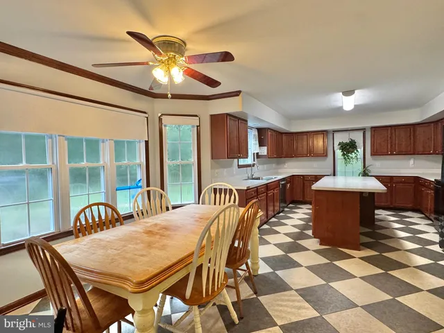 a kitchen with stainless steel appliances granite countertop a refrigerator a sink dishwasher a stove with wooden cabinets and floor