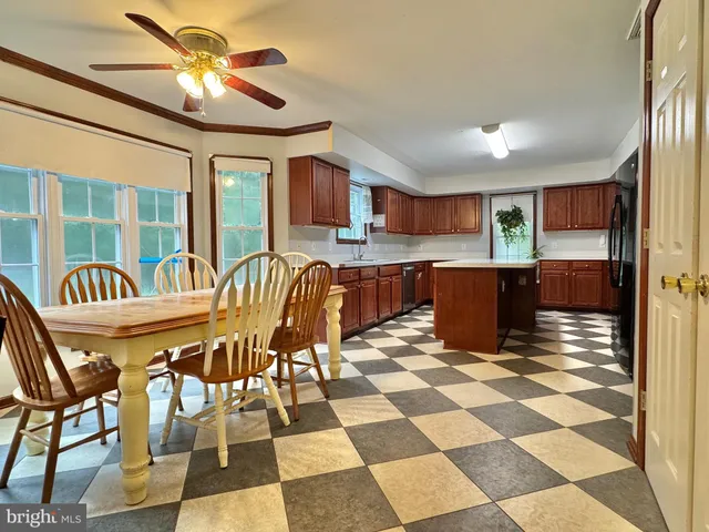 a kitchen with stainless steel appliances granite countertop a sink and a refrigerator