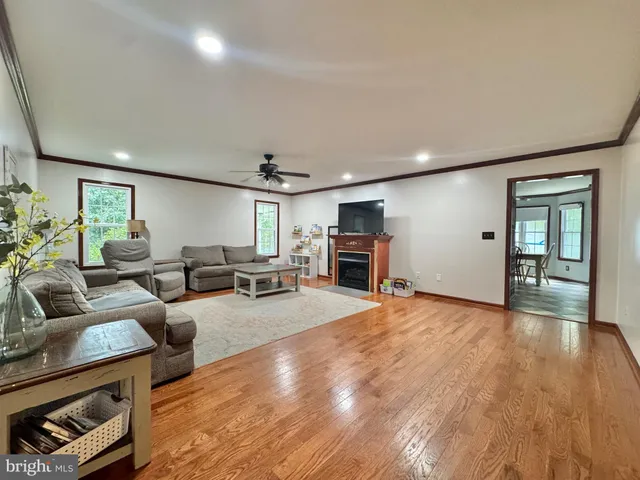 a living room with a table and a bookshelf
