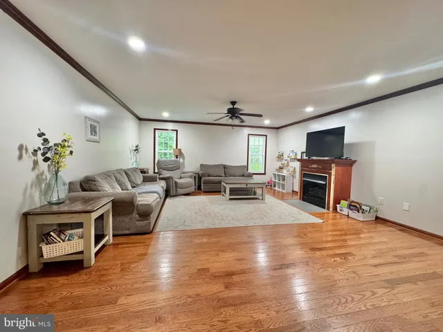 a living room with a piano table and wooden floor