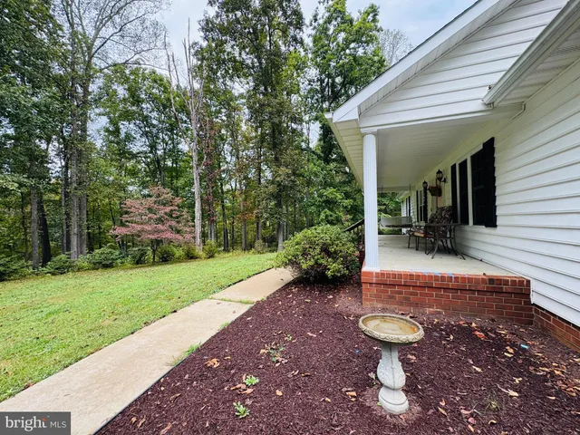 a view of a backyard with sitting area