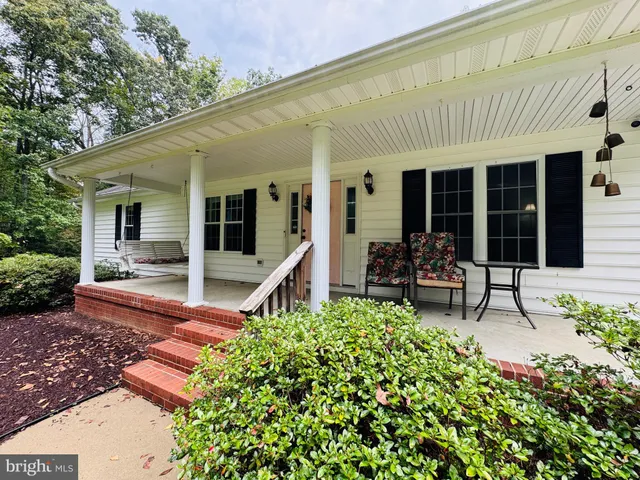 a house view with a sitting space and garden