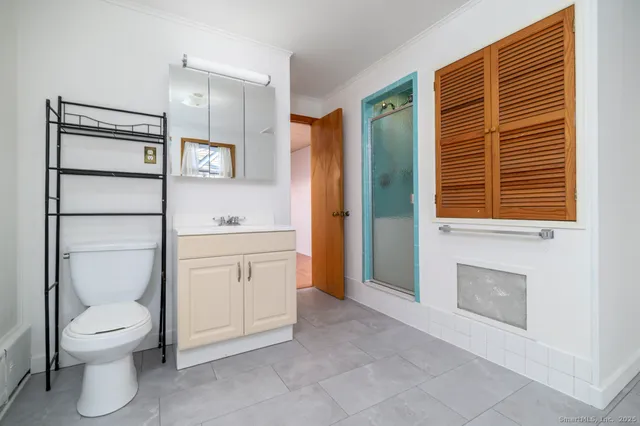 a spacious bathroom with a toilet sink and shower
