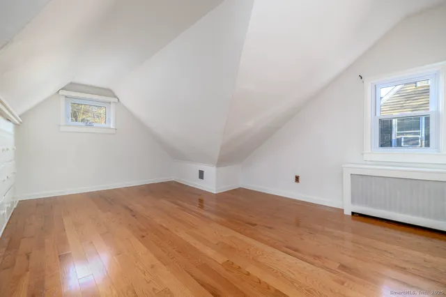 a view of a room with wooden floor and window