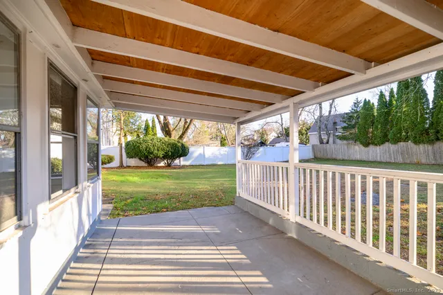a view of a house with a yard and sitting area
