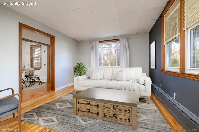 a dining room with furniture and wooden floor