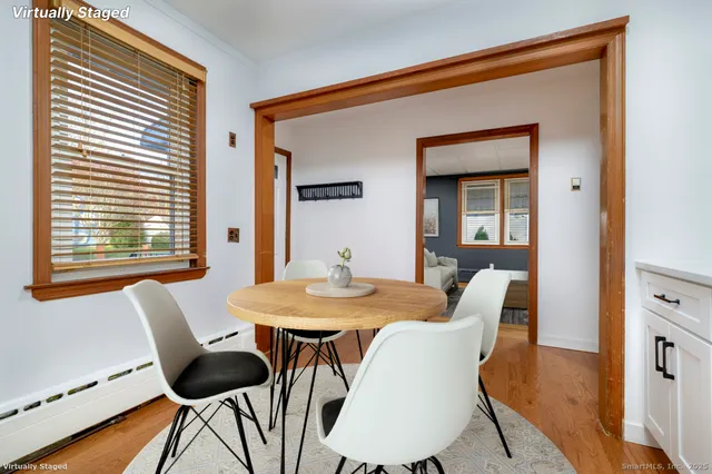 a view of a dining room with furniture and wooden floor