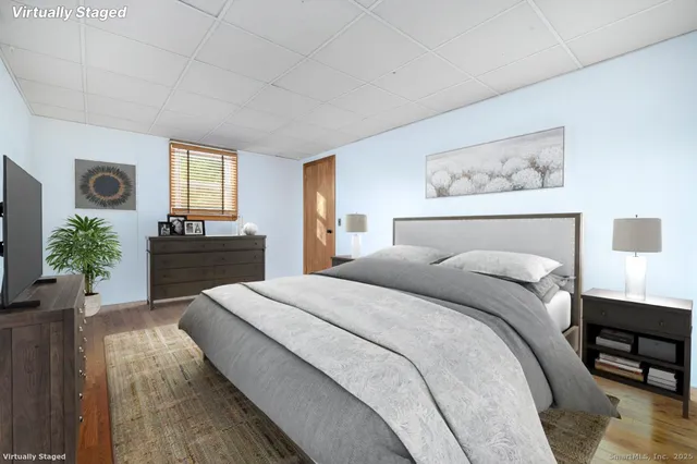 a bedroom with a bed and a flat screen tv