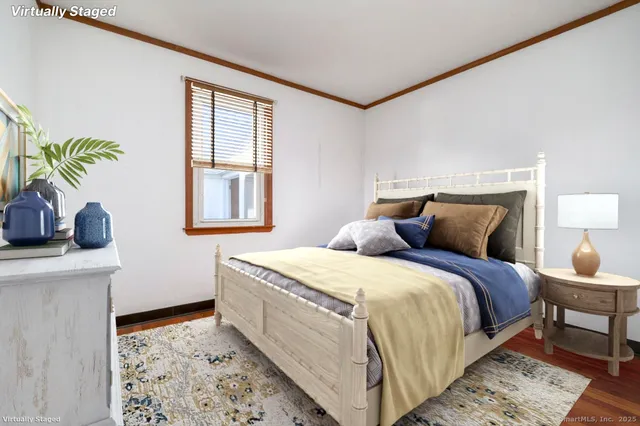 a bedroom with a bed a dresser next to a window