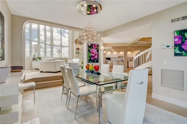 a dining room with furniture a livingroom and chandelier