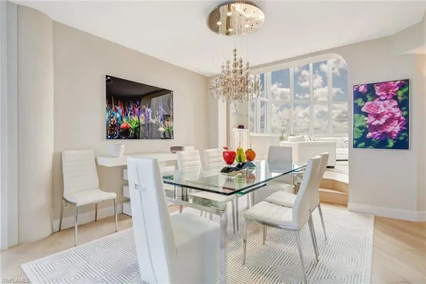 a view of a dining room with furniture and a chandelier