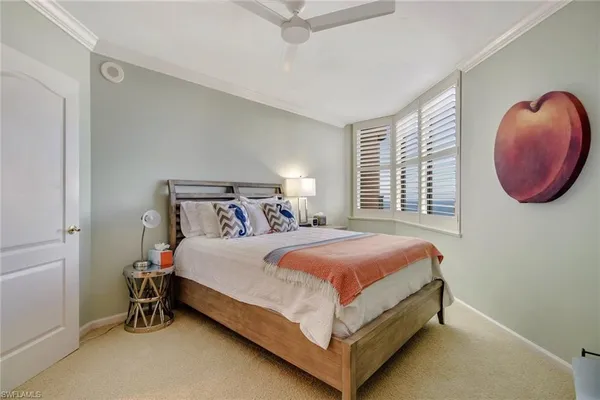 a bedroom with a large bed and a chair