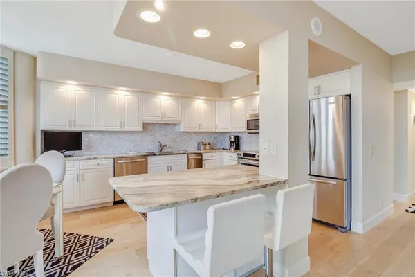 a large kitchen with a table and chairs