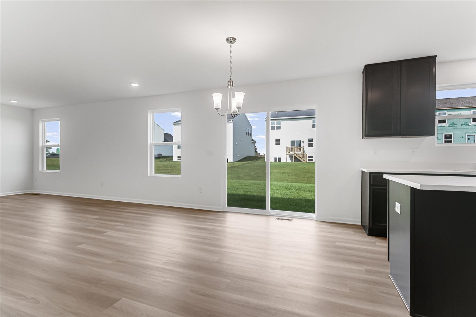620 Endicott Road South Elgin, IL 60177 - Photo 12 of 30 an empty room with wooden floor fireplace and windows
