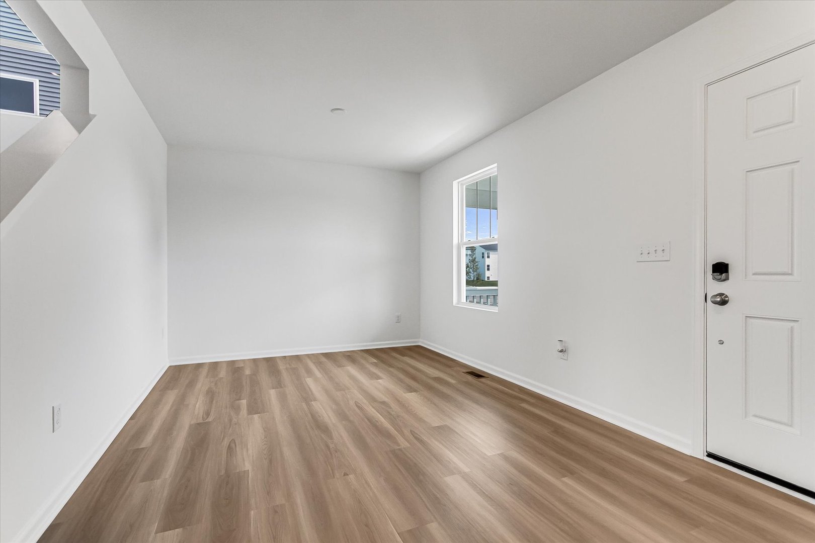 620 Endicott Road South Elgin, IL 60177 - Photo 4 of 30 an empty room with wooden floor and windows