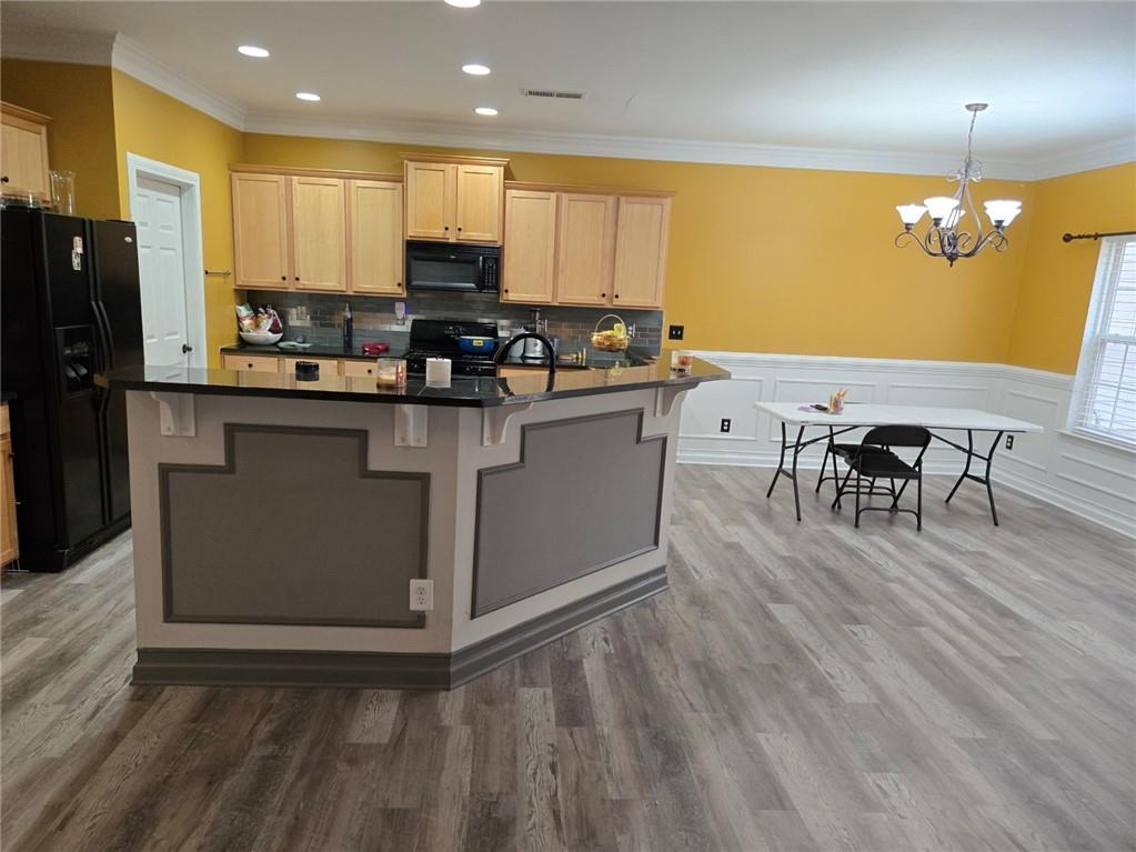 2900 Suttles Drive Southwest Atlanta, GA 30331 - Photo 7 of 23 a kitchen with stainless steel appliances granite countertop wooden cabinets a refrigerator a stove a sink and a island