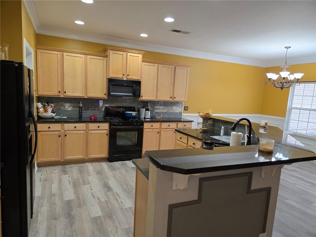 2900 Suttles Drive Southwest Atlanta, GA 30331 - Photo 9 of 23 a kitchen with kitchen island granite countertop a sink appliances cabinets and a counter top space
