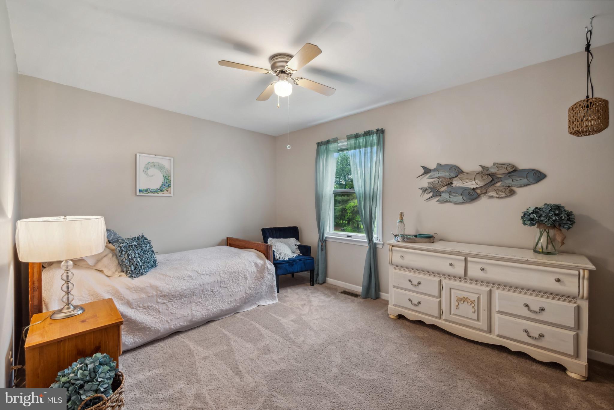 3825 Salem Bottom Road Westminster, MD 21157 - Photo 15 of 43 a bedroom with a bed and a chandelier