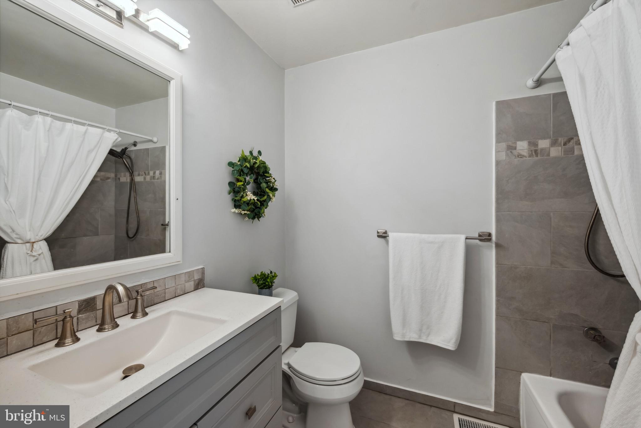 3825 Salem Bottom Road Westminster, MD 21157 - Photo 19 of 43 a bathroom with a sink toilet and a mirror