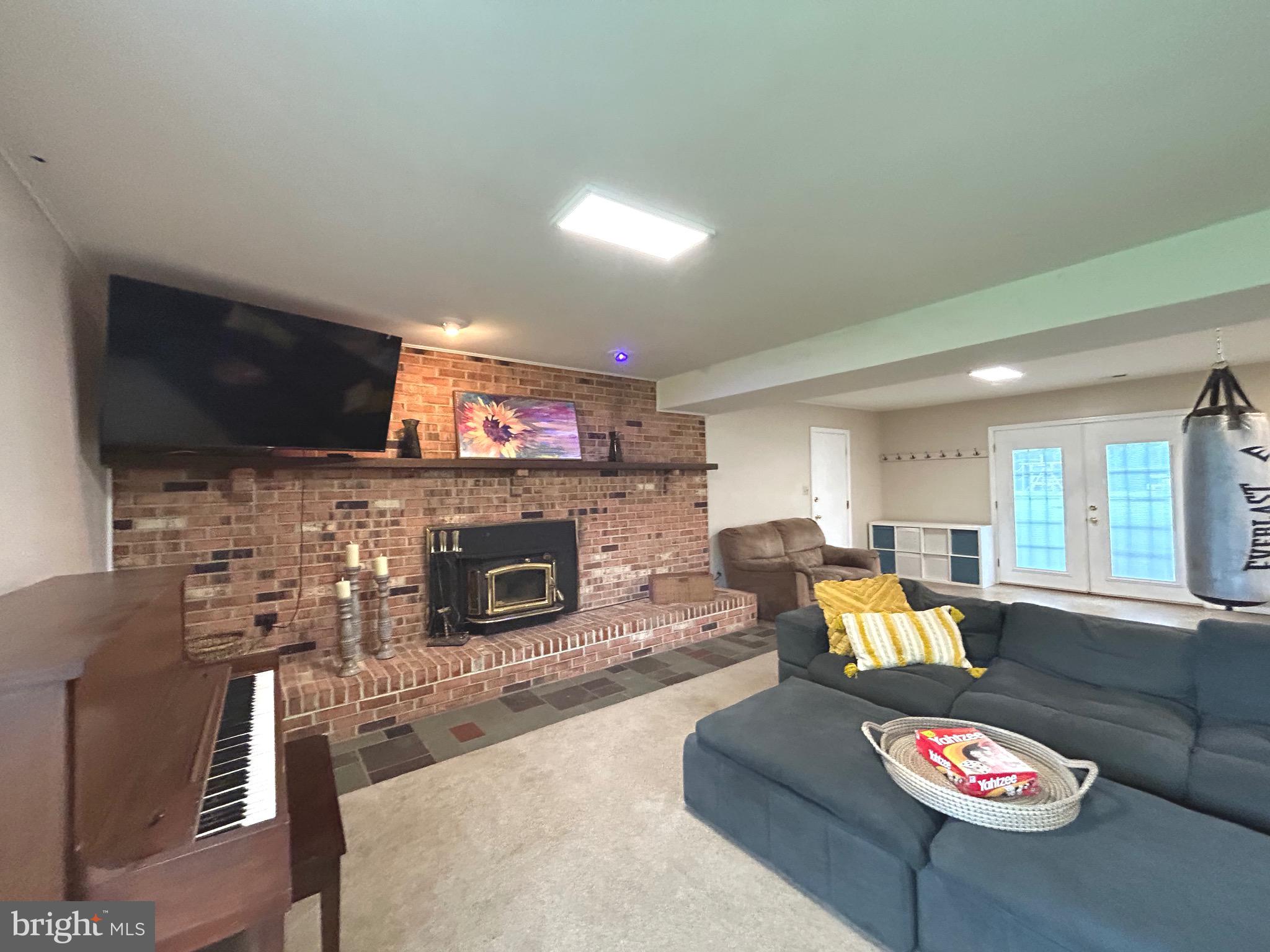 3825 Salem Bottom Road Westminster, MD 21157 - Photo 24 of 43 a living room with fireplace furniture and a flat screen tv