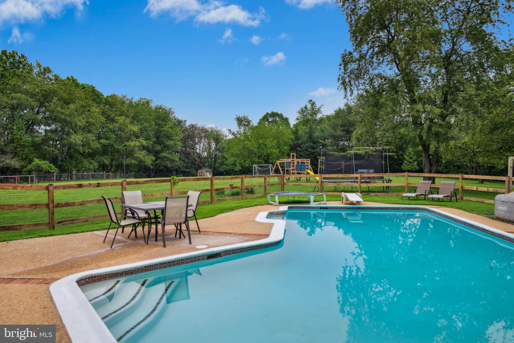 3825 Salem Bottom Road Westminster, MD 21157 - Photo 4 of 43 a view of a swimming pool with a table and chairs